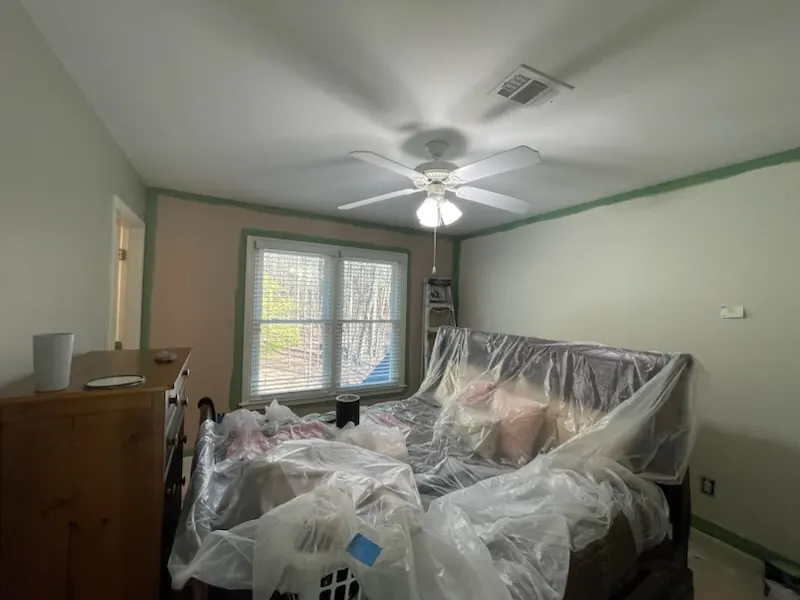 Bedroom furniture wrapped in plastic before painting